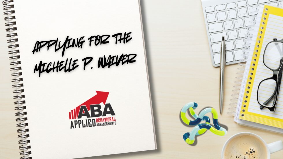 A desk displaying a notebook that says "Applying for the Michelle P. Waiver" and features the ABA, LLC logo