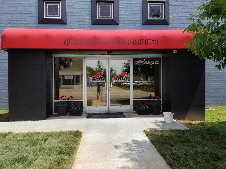 ABA-LLC's downtown headquarters, a grey building with a red awning